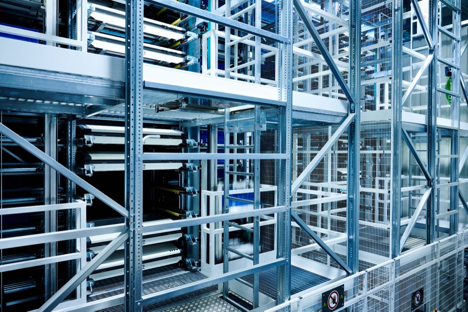Automated storage and conveyor structure in an implemented warehouse environment